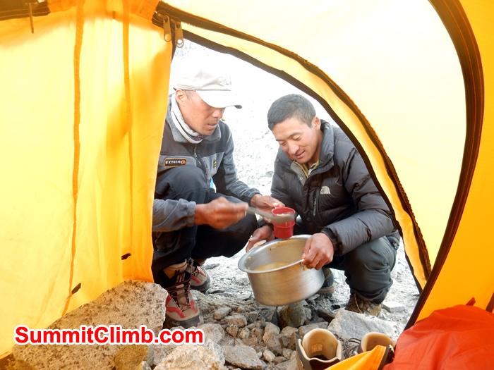 Tenji and Ang Pasang serving food in Tent. Photo Erik